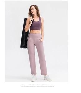 Detail of high-waist loose yoga pants with side pockets in soft pastel purple color