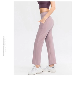 Detail view of high-waisted yoga pants with side pockets in mauve grey color