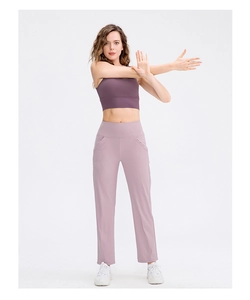 Detail view of high-waisted yoga pants with functional side pockets and smooth fabric