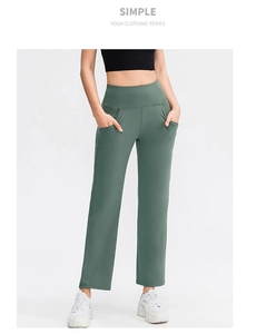 Detail of green high-waisted yoga pants with side pockets and smooth matte texture