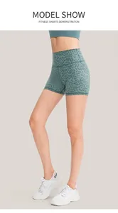 Detail showing high-waisted green leopard print yoga shorts with butt-lifting seam