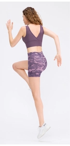 Detail of purple camouflage high-waisted yoga shorts with elastic performance fabric