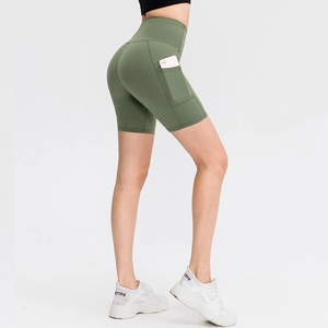 High-waisted dark green yoga shorts with side pockets and slimming tummy control