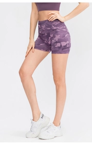 Detail of high-waist purple camo yoga shorts showing compression fabric and fit
