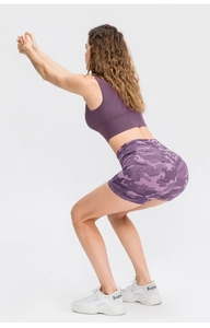Detailed side view of purple camo yoga shorts showing high elasticity during squats