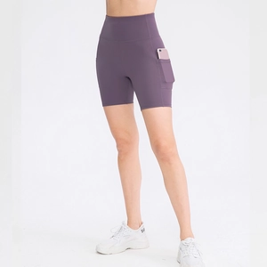 Purple high-waisted yoga shorts with side pockets and elastic fabric on white background