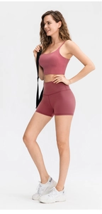 Pink high-stretch yoga set with cross-back sports bra and high-waisted fitness shorts