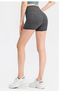 Close-up of leopard print yoga shorts highlighting high-waist fit and elastic fabric