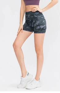 Detail of high-waisted camouflage yoga shorts showing elastic fabric and side fit