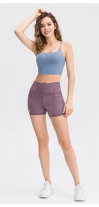 Detail of high-waist purple marble yoga shorts with blue racerback sports bra for gym