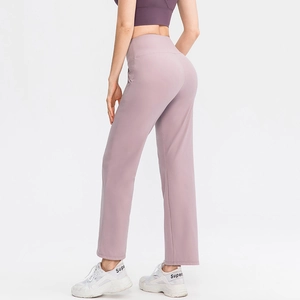 High-waisted loose yoga pants in light purple shown from a rear side perspective view