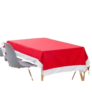 Festive red non-woven Christmas tablecloth with white trim on a rectangle dining table
