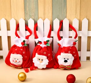 Detailed view of plush Christmas drawstring gift bags featuring snowman and Santa designs