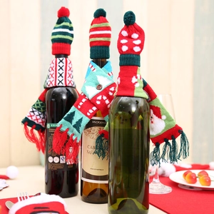 Knitted Christmas wine bottle covers featuring mini hats and scarves in festive patterns