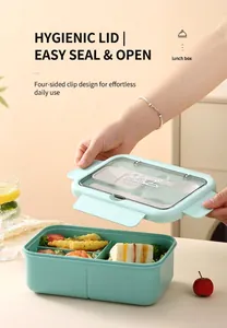 Detail of mint green bento box with four-sided locks and clear cutlery compartment