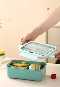 Detail of mint green bento box with four-sided locks and clear cutlery compartment