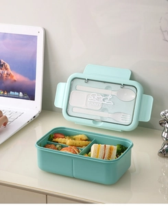 Detail of mint green bento box with built-in cutlery storage and compartment design