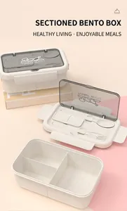 Close-up of three-compartment bento box with built-in utensils and YUMMY BENTO lid logo