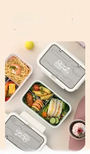 Detail of multi-compartment bento box lid with YUMMY BENTO logo and grey finish