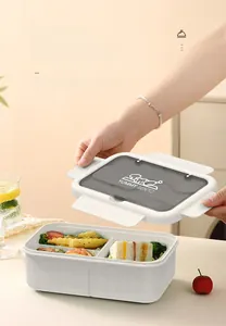 Detailed view of opening a compartmentalized bento box with a secure sealing lid
