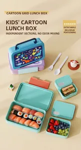 Close-up of kids dinosaur grid lunch box with separated sections and plastic utensils
