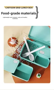 Top view of mint green cartoon lunch box with food-grade sections and plastic cutlery