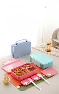 Macro detail of portable divided lunch boxes with handle and utensils in three colors