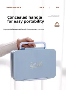 Close-up of a blue bento box with divided compartments and ergonomic folding handle