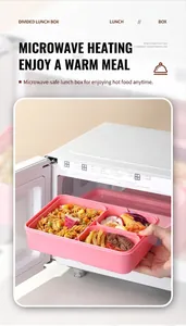 Pink compartmentalized bento box being placed into a microwave for heating demonstration