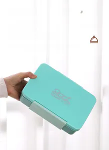 Detail of mint green bento box lid with secure side buckles and leakproof silicone seal