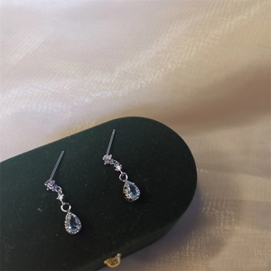 Elegant light blue teardrop pendant earrings in S925 silver on a green velvet box