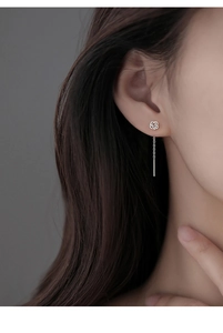 Detail of S925 silver rose tassel earrings on model showing elegant minimalist drop design