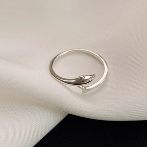 Minimalist S925 sterling silver snake ring with sparkling zircon eyes on silk background