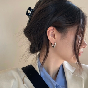 Polished silver heart hoop earrings with a minimalist three-dimensional design for women