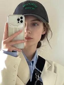 Mirror selfie showing a silver heart-shaped earring detail on model with casual style