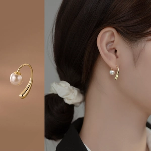 Elegant gold drop earrings with white pearls shown in detail and on model view