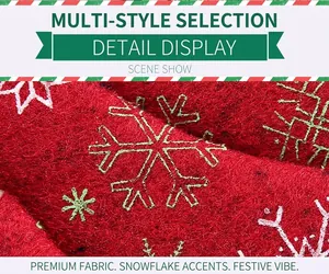 Macro detail of red felt Christmas tree ornament with white snowflake embroidery