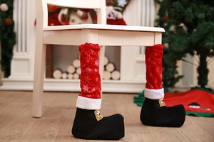 Close-up of Santa boot chair leg cover with snowflake pattern and gold buckle detail