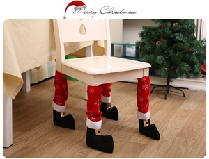 Close-up of red snowflake Christmas chair leg covers with black elf shoe design
