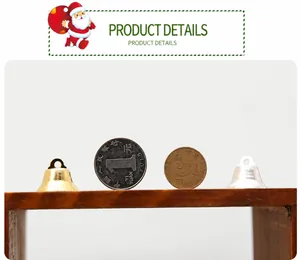Detailed comparison of 20mm gold and silver metal Christmas bells with coins for size reference