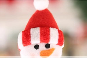 Close-up of Christmas snowman handle cover featuring a red knit hat and carrot nose