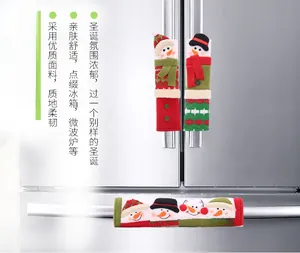 Detail of Christmas snowman fridge handle covers on stainless steel refrigerator doors