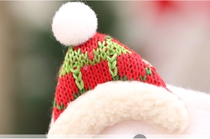 Close-up of a festive Christmas knit hat accessory with soft white pompom and plush trim