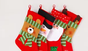 Close-up of four large Christmas stockings with bear, snowman, Santa, and reindeer designs