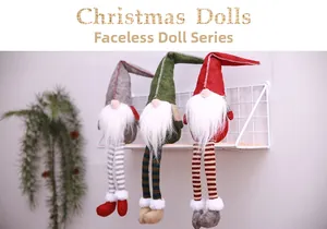 Detailed view of three knitted Christmas gnomes in red, green and grey on a white stand