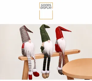 Three long-legged Christmas gnomes sitting on a wooden bench for holiday decoration