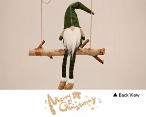 Close-up of a Christmas gnome sitting on a wooden swing with green hat and striped legs