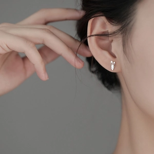 Cute S925 silver rabbit and carrot stud earring worn by model in a minimalist style