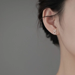 Cute S925 sterling silver rabbit stud earrings with bow detail on female model