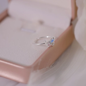 Detail of 3D silver butterfly ring with colorful cubic zirconia in a jewelry box